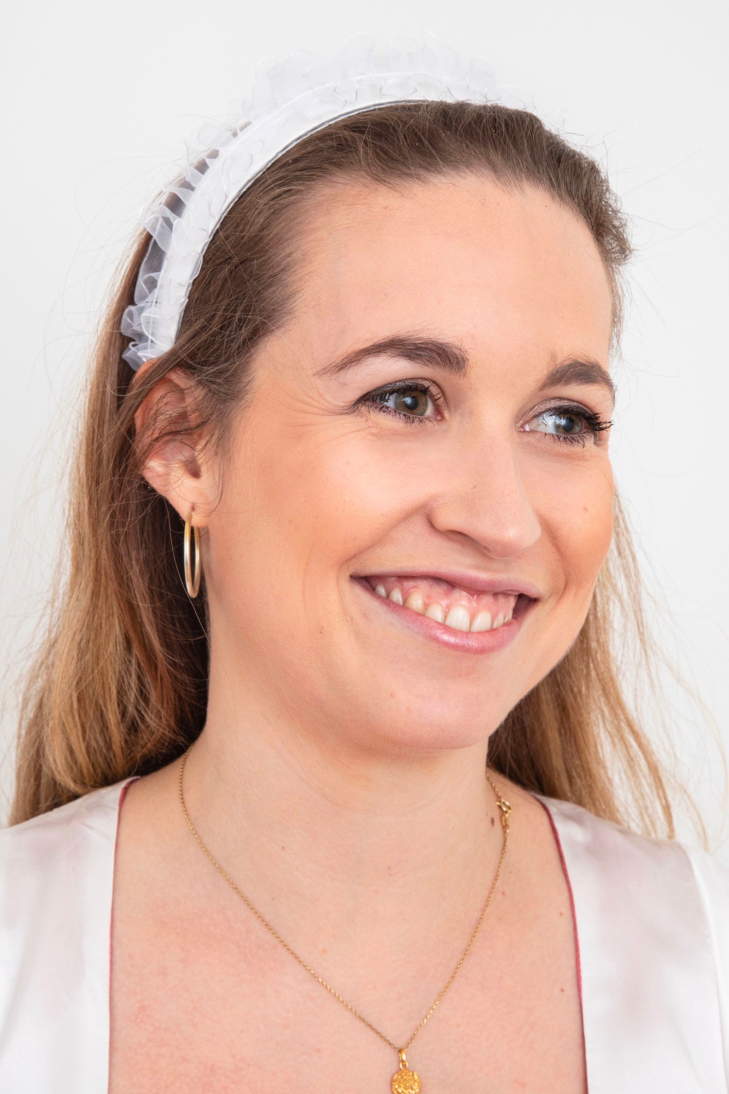a pretty bridal headband with a handmade organza ruffle looks beautiful and stylish on a model