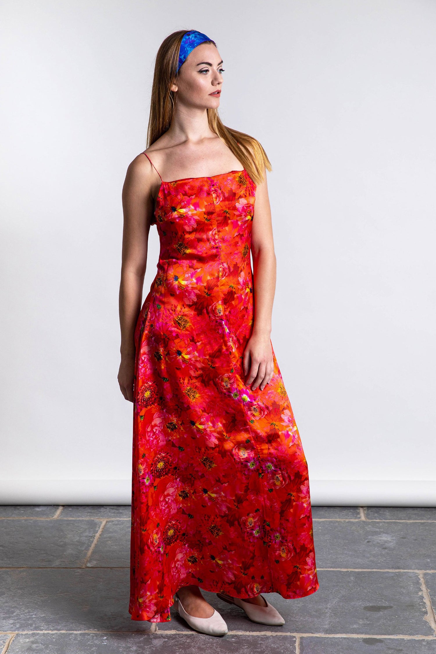 coral coloured floral printed silk satin long slip dress worn by model