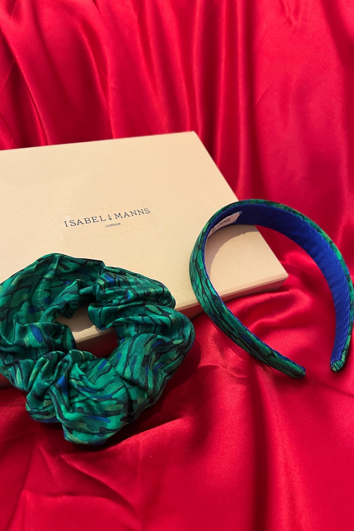 a gift box featuring a green printed silk scrunchie and headband