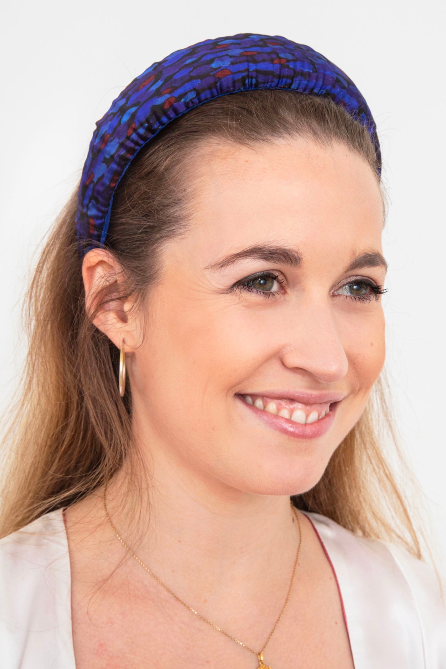 A unique blue printed satin headband worn elegantly by a model