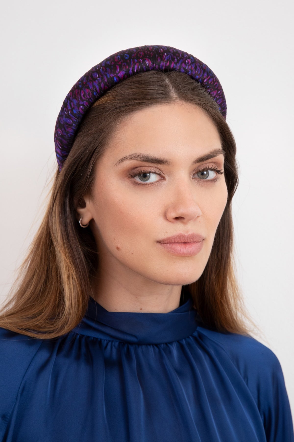 A beautiful silk satin headband in our Purple Mystery print gives you a versatile and stylish hair accessory worn by a stunning model