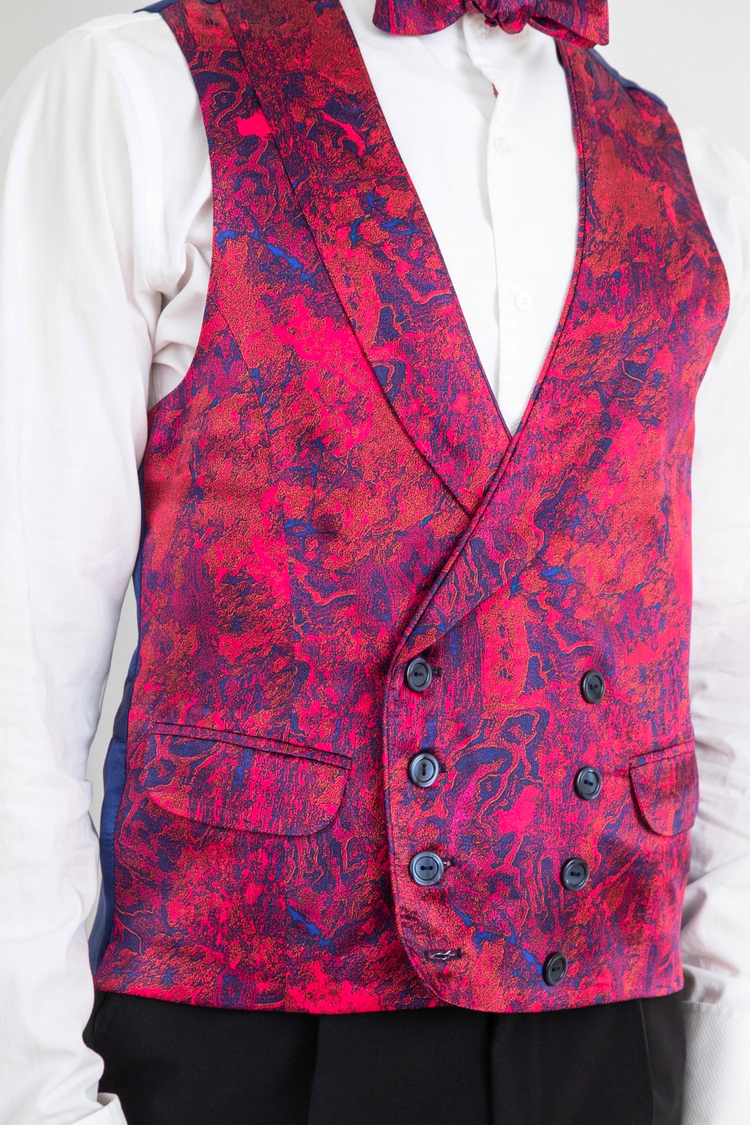 Men's bespoke waistcoat by Isabel Manns, featuring a vibrant red and blue Fire Ocean print with double-breasted buttons, handcrafted for a unique and stylish look