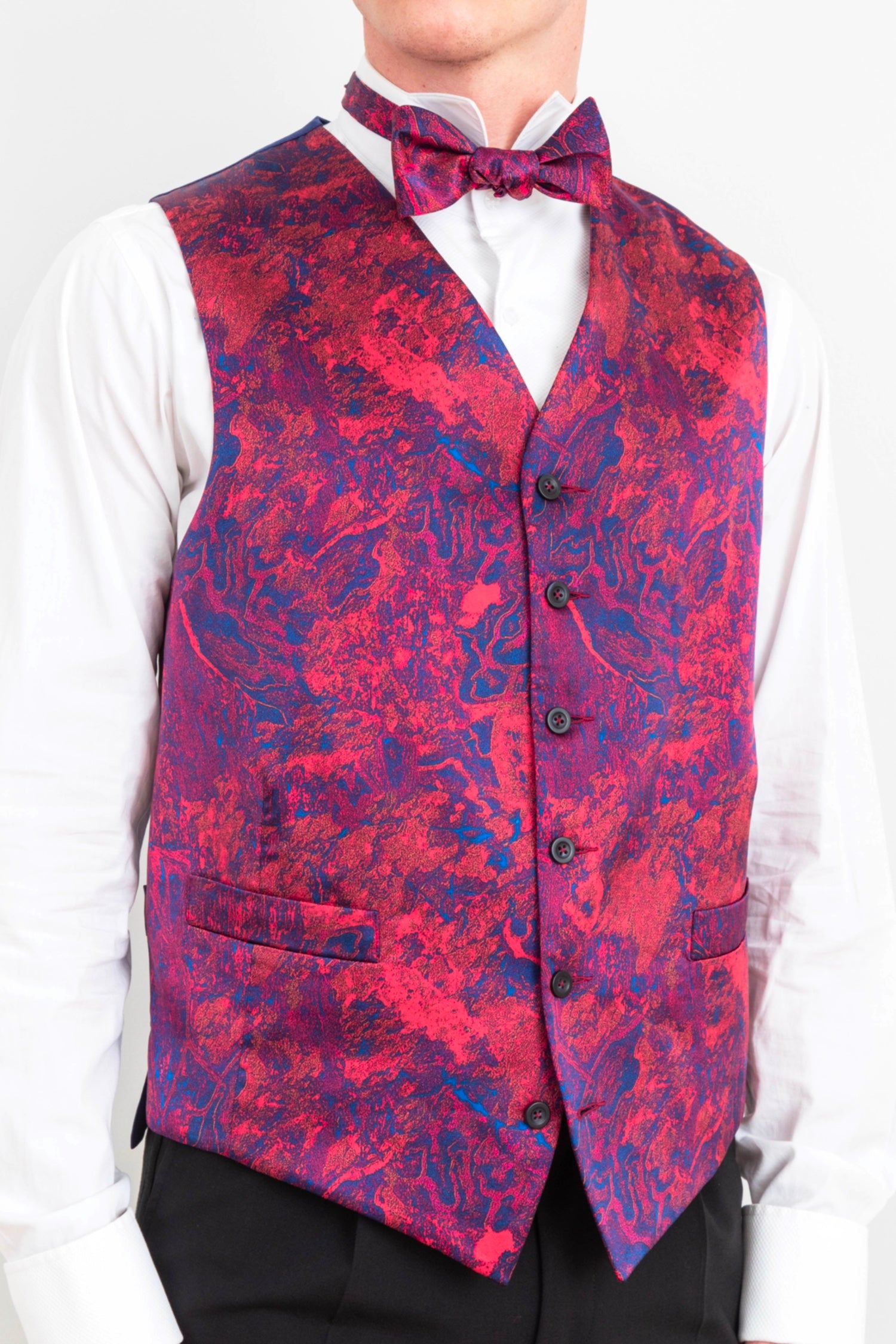 Men's bespoke waistcoat by Isabel Manns, featuring a vibrant red and blue Fire Ocean print with single-breasted buttons, handcrafted for a unique and stylish look