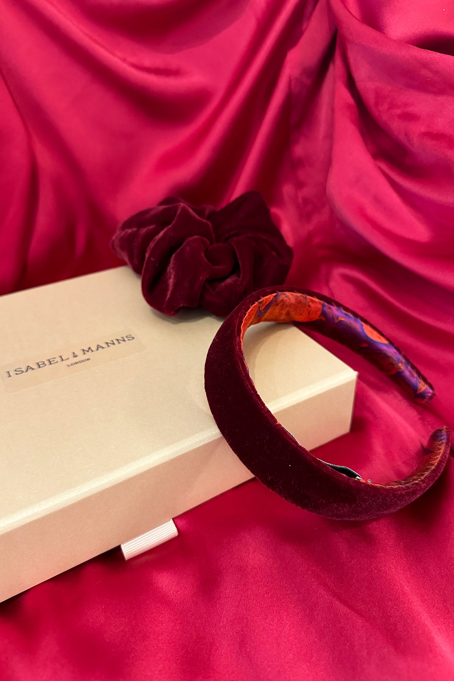 Burgundy velvet headband with matching scrunchie and medium pink gift box bow tied ribbon.