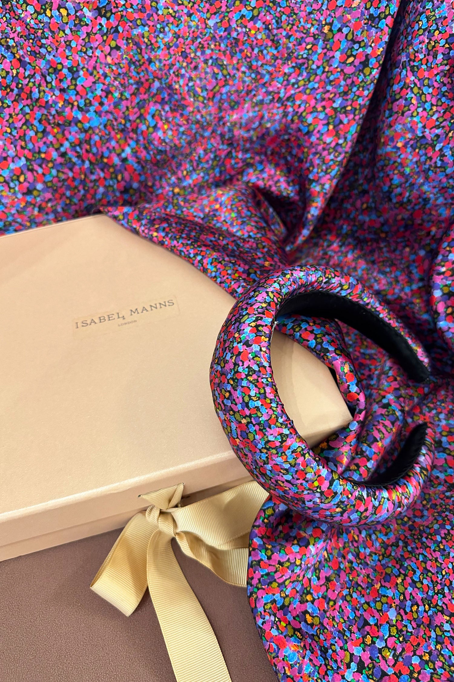Long double-sided silk satin scarf in pink and purple dotted print, with matching padded headband, and large pink gift box bow tied ribbon.