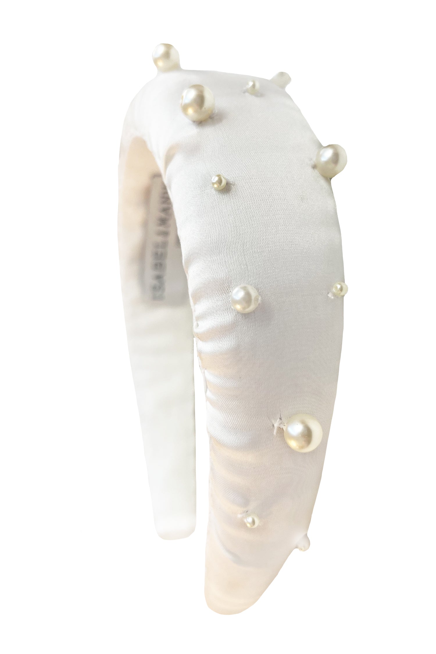 a glamorous white silk padded headband with beautiful pearl detail spread out over the headband