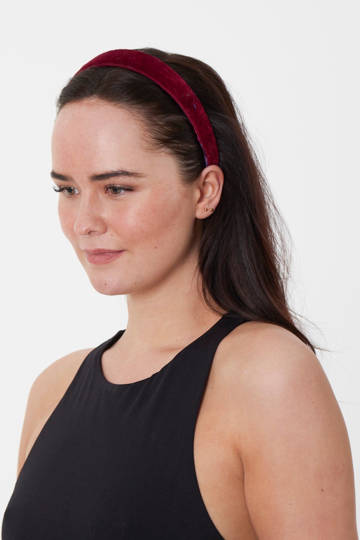 model wearing elegant burgundy velvet headband with a soft, luxurious finish, perfect for adding a touch of sophistication to any outfit.