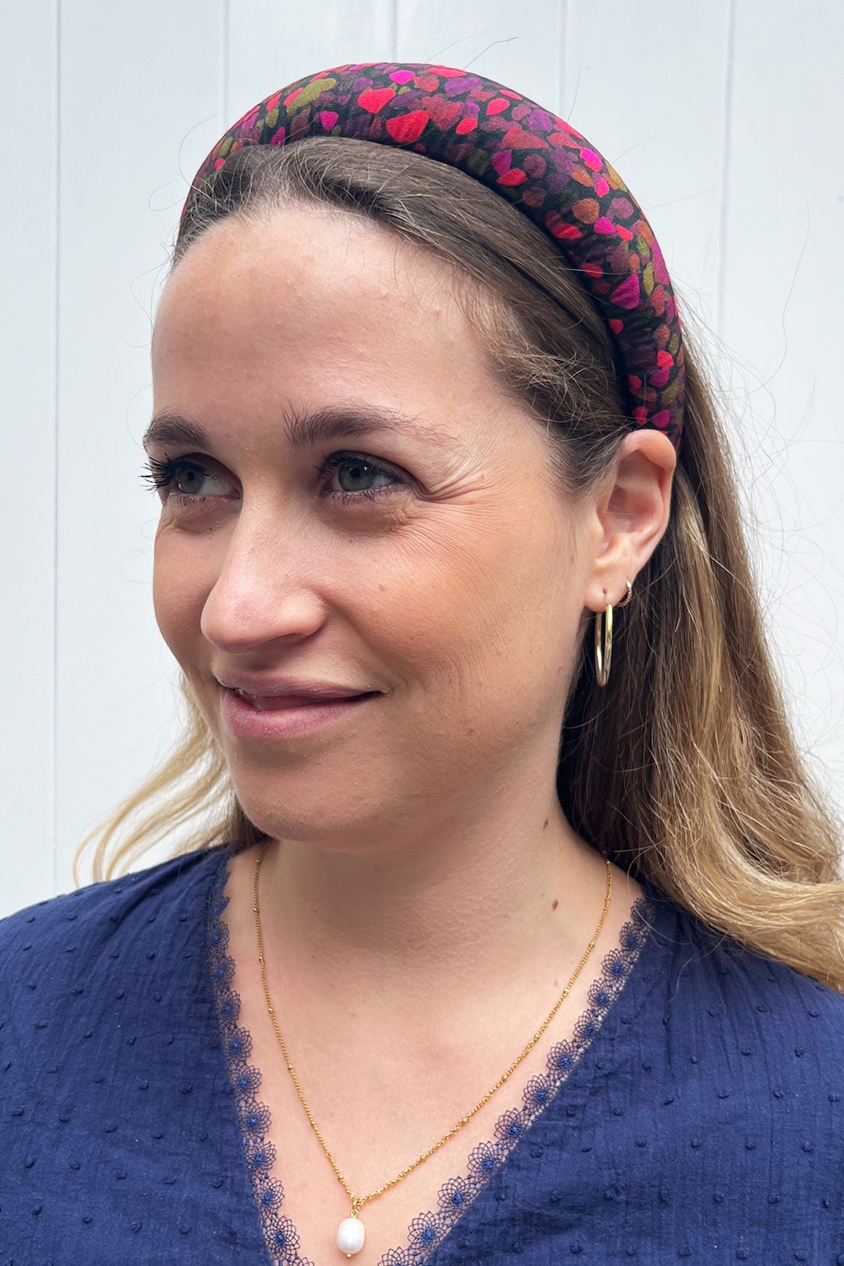 model showcasing a pink and brown silk printed headband that is classic
