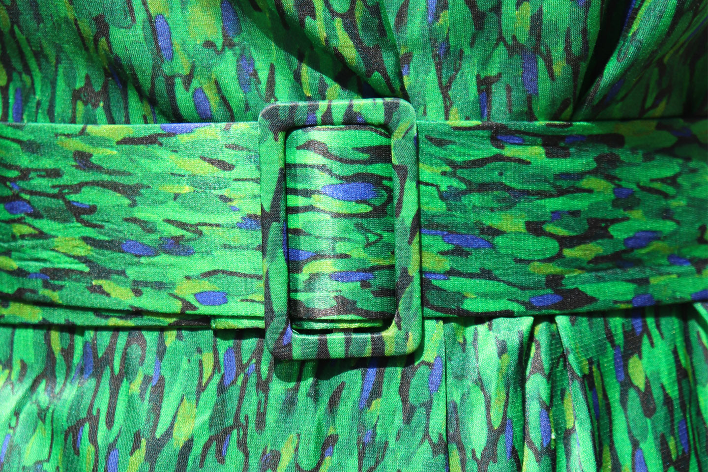 a flecked emerald green belt on a dress