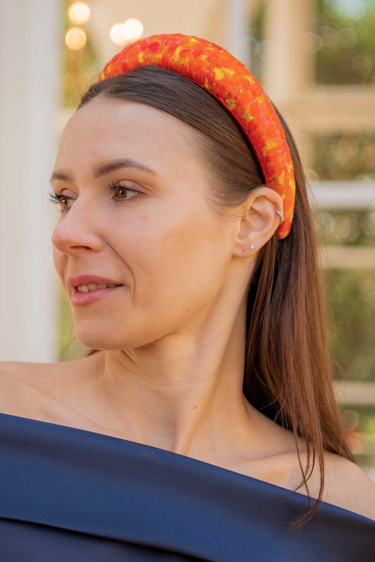 pixelated afterglow orange printed padded headband on model
