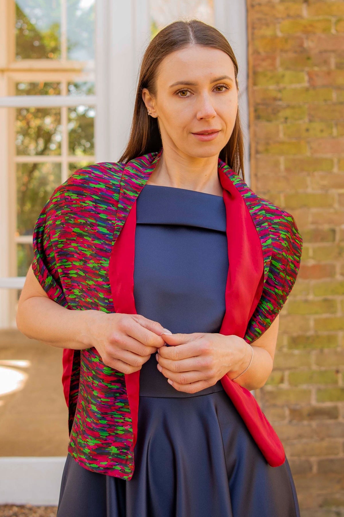 a reversible colourful scarf being worn over a gown by a model