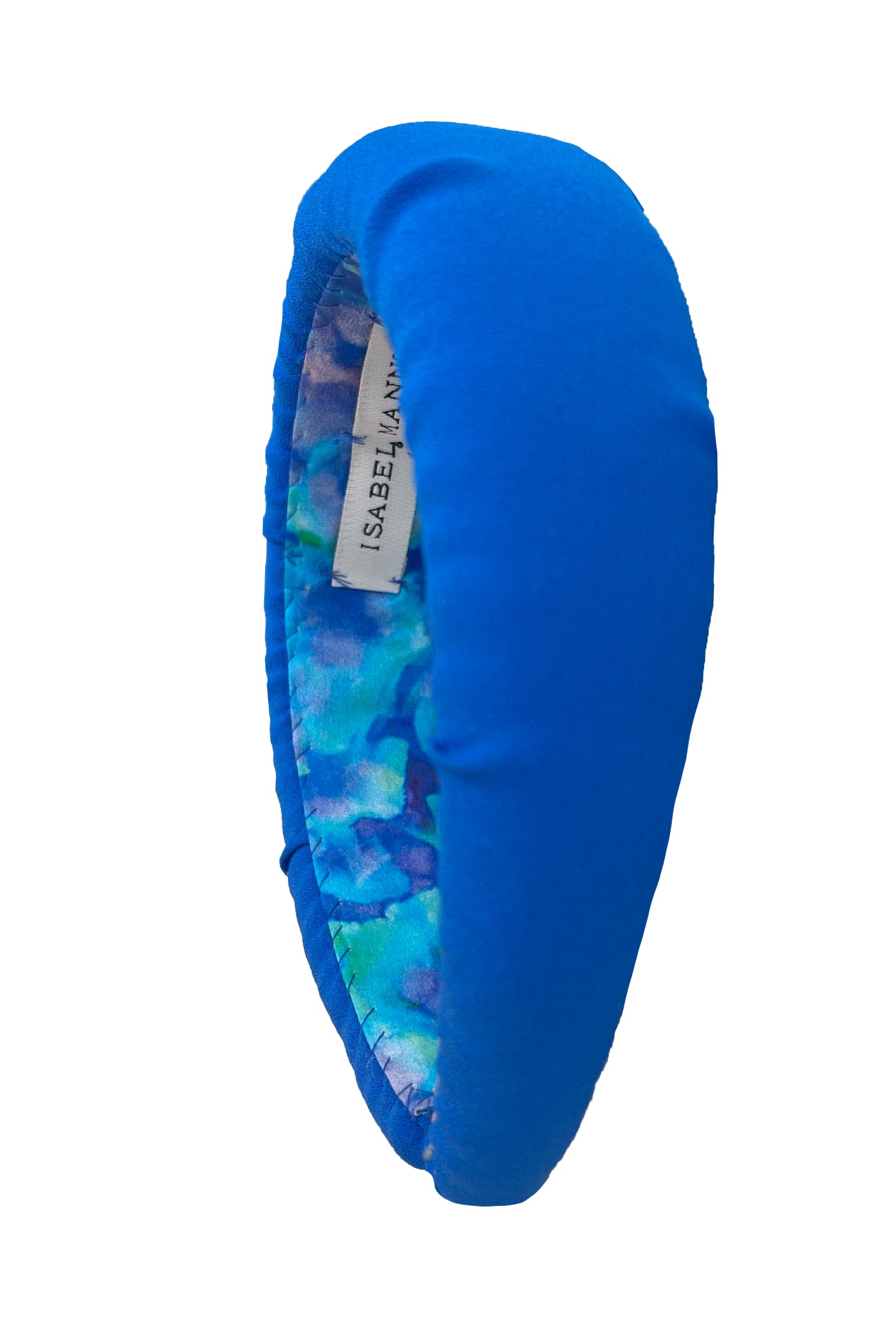 A turquoise padded headband that is sustainable and handmade