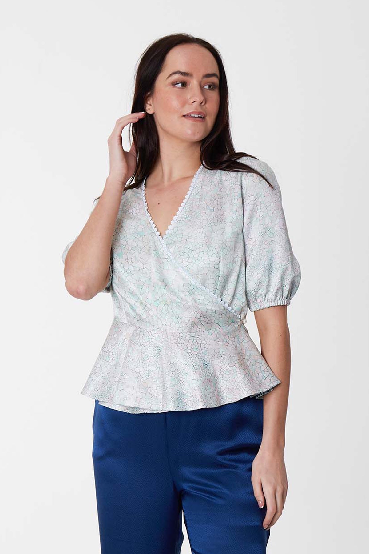 Reversible wrap peplum silk bamboo top with elbow length sleeves in pastel blue.