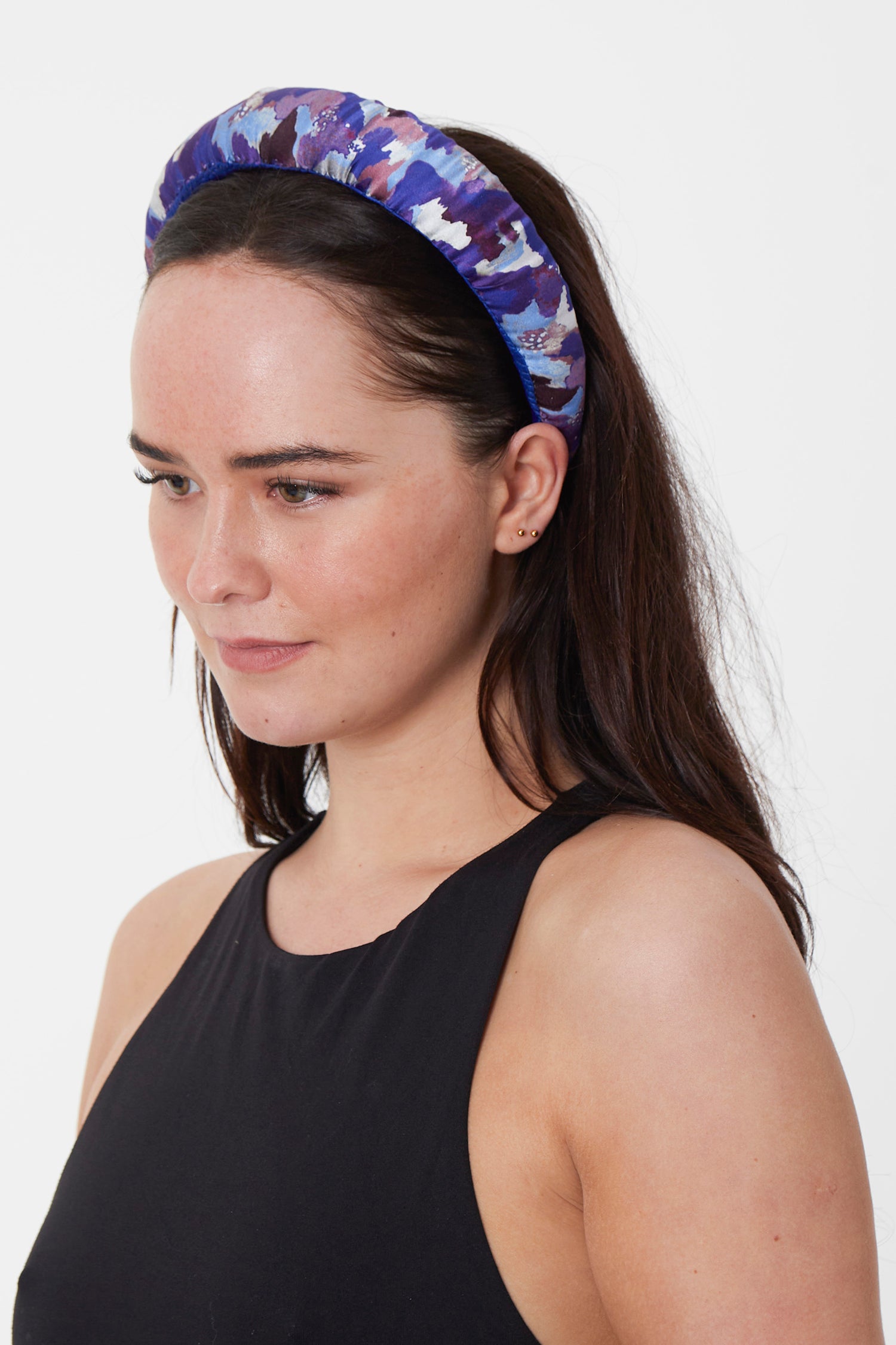 a violet printed padded headband with shades of cobalt and white throughout the print