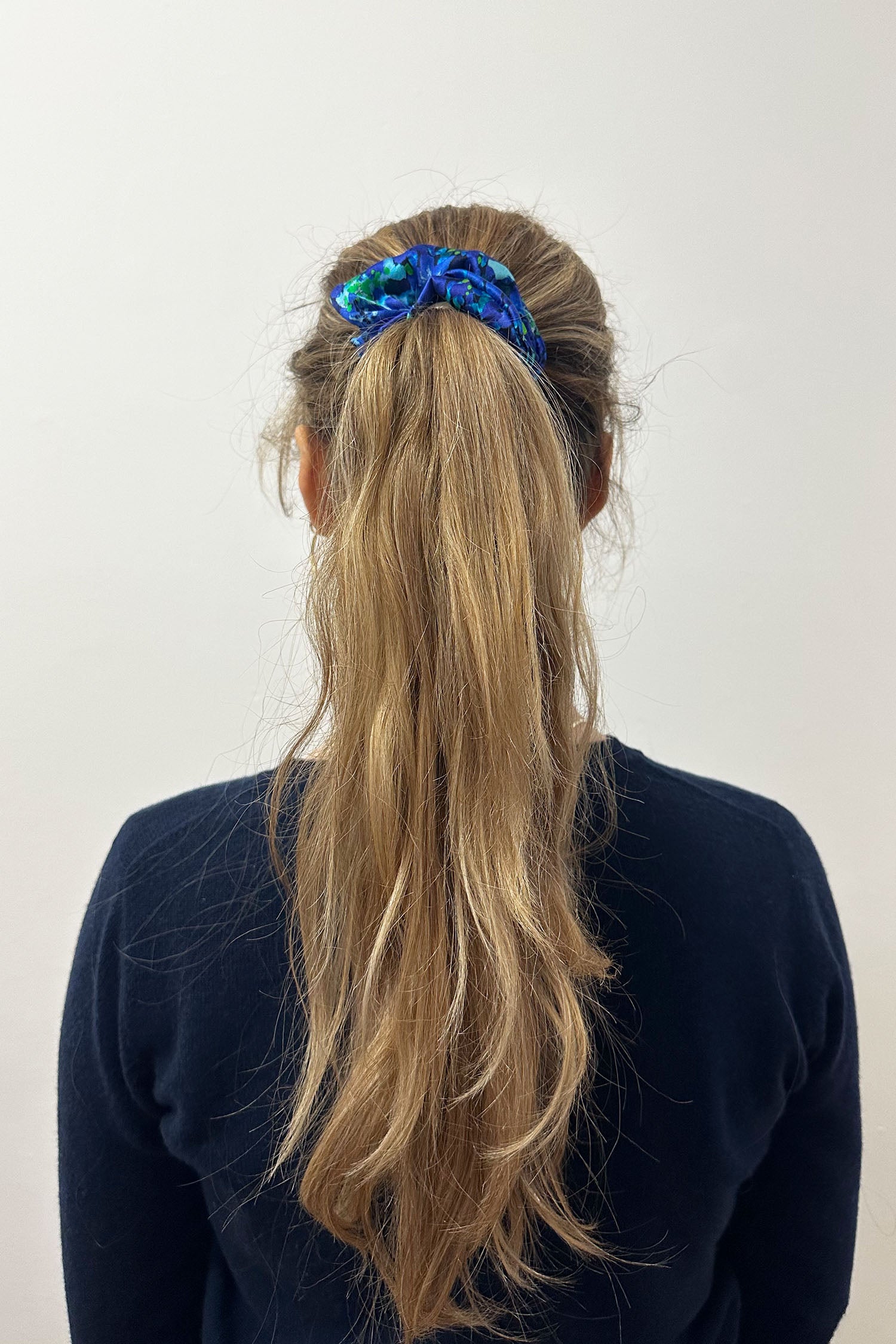Model wearing blue floral print silk satin scrunchie.