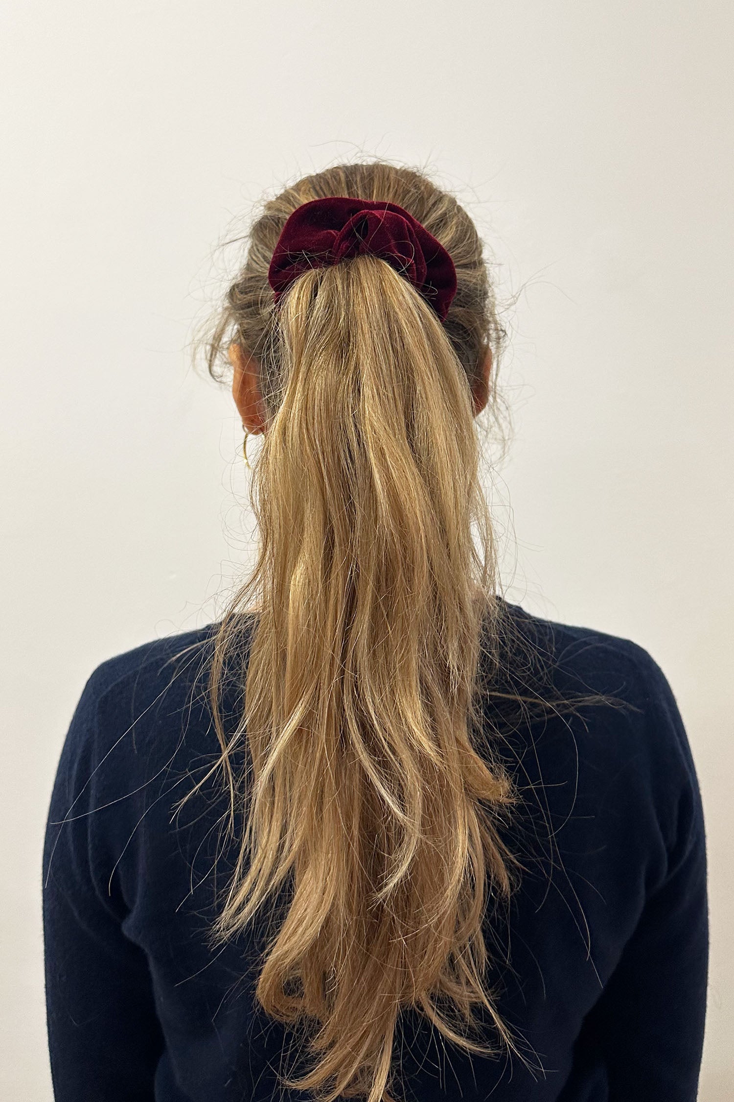 Model wearing burgundy velvet scrunchie.