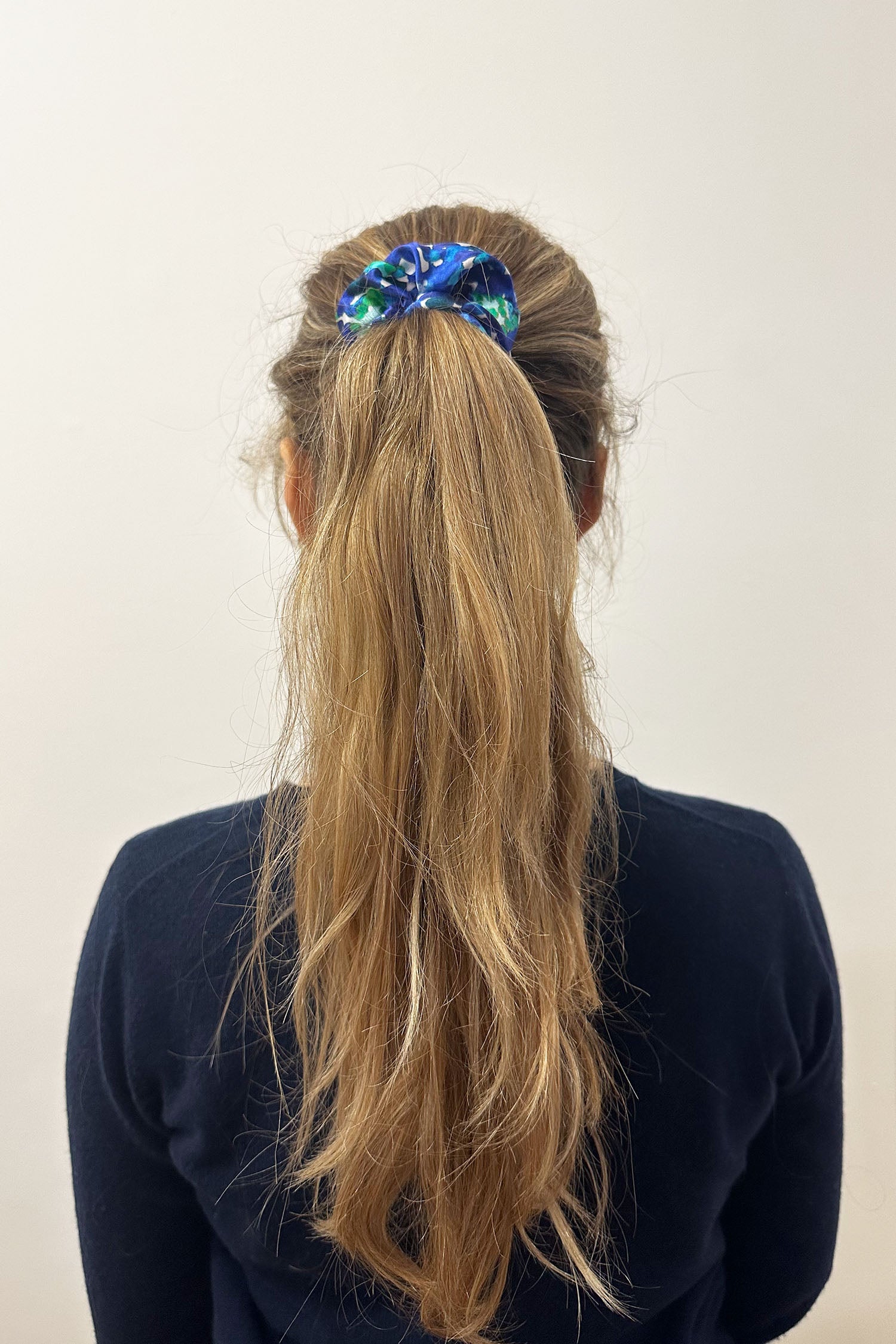 Model wearing blue floral print silk satin scrunchie.