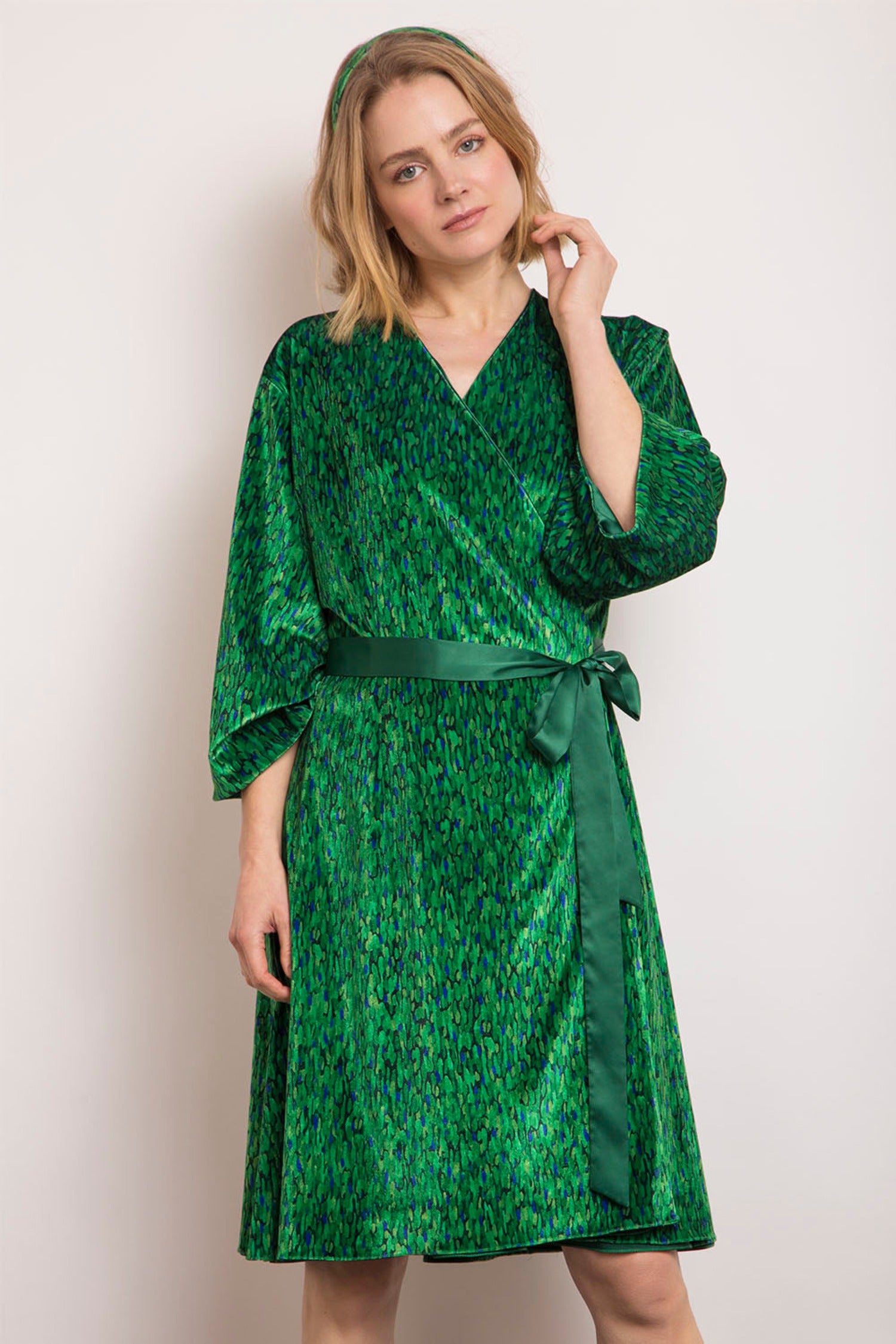 Model wearing reversible knee length velvet vibrant green print velvet kimono.