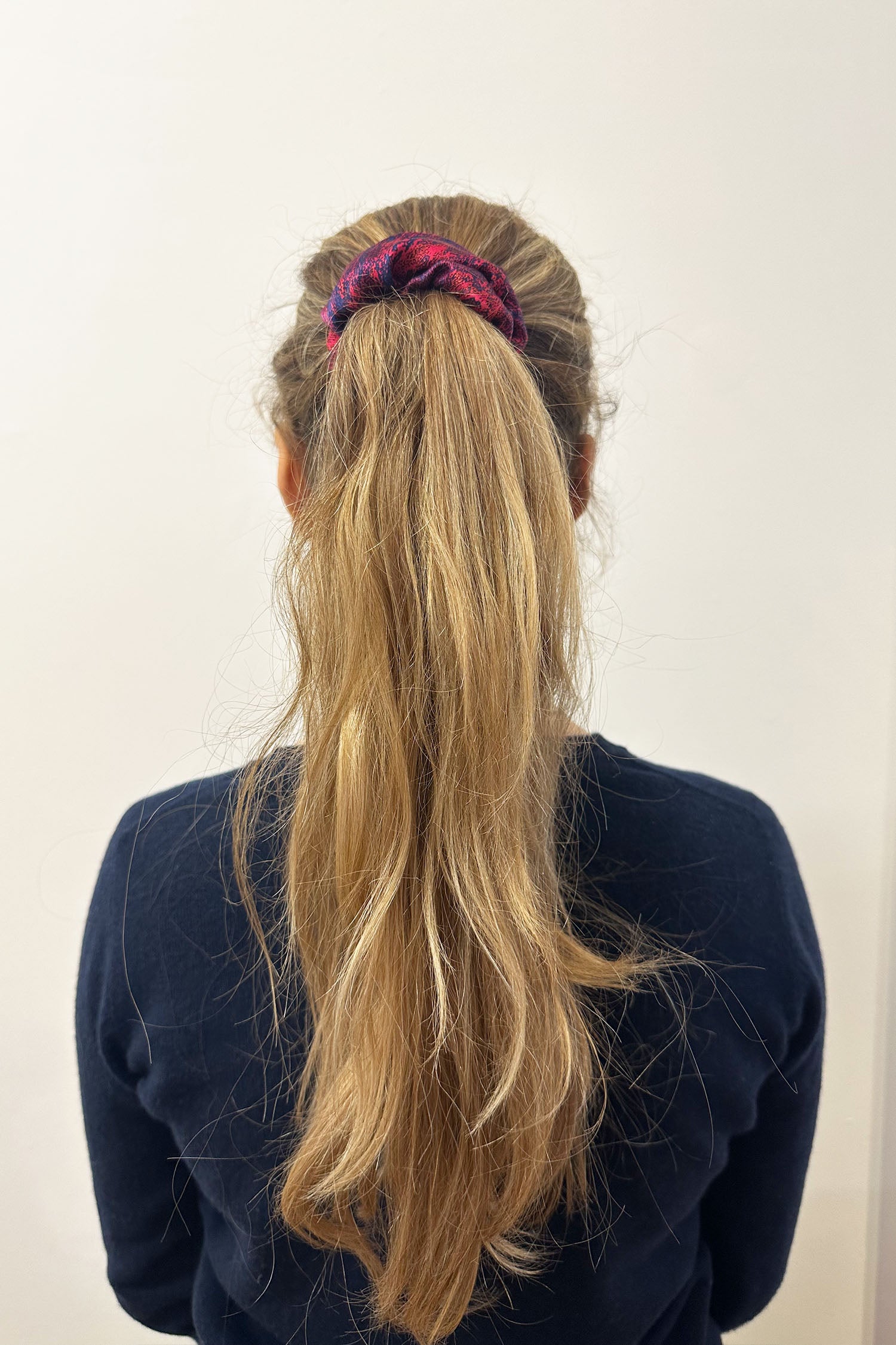 Model wearing red marbleprint silk satin scrunchie.