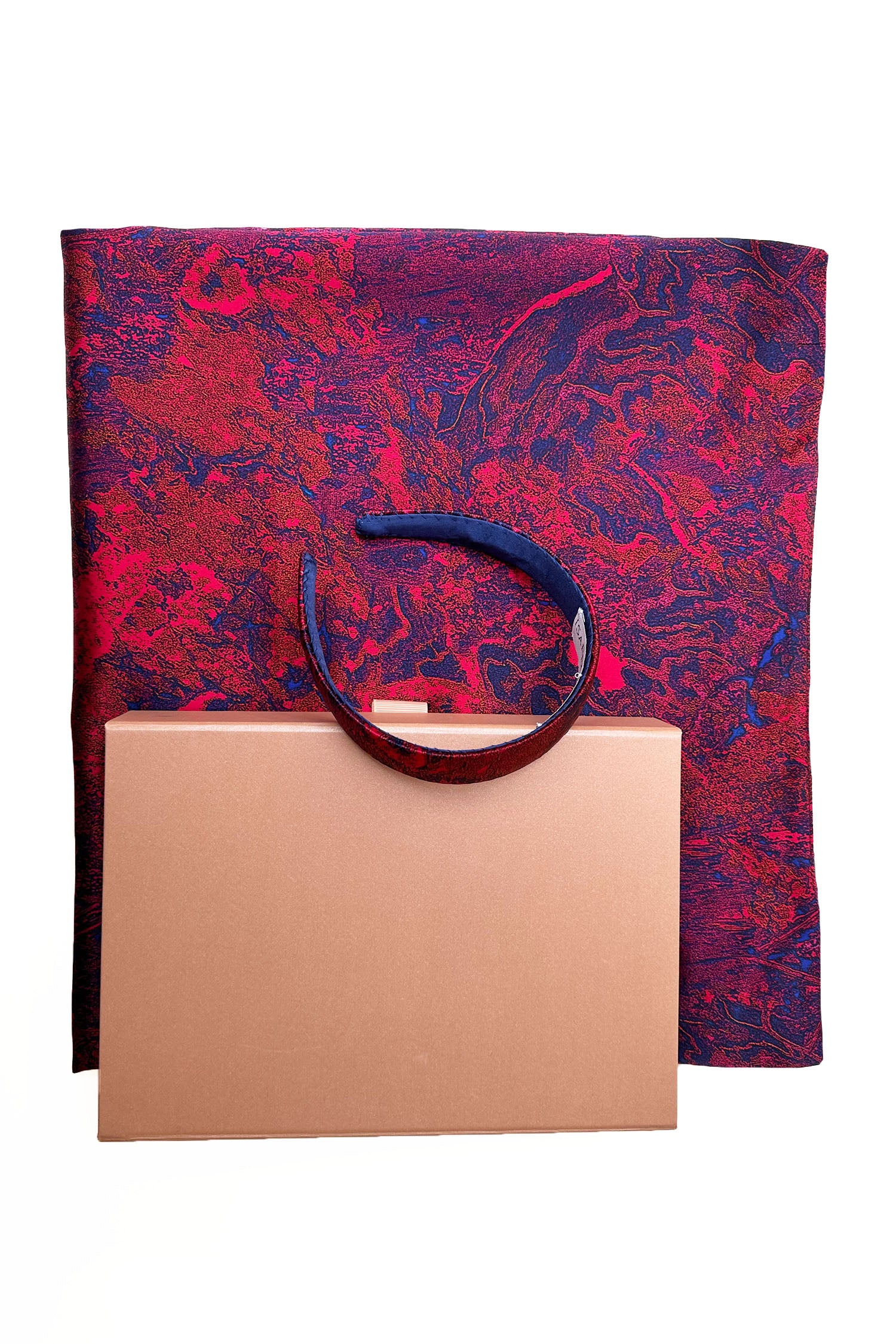 Long double-sided silk satin scarf in red marble print, with matching headband and large pink gift box bow tied ribbon.