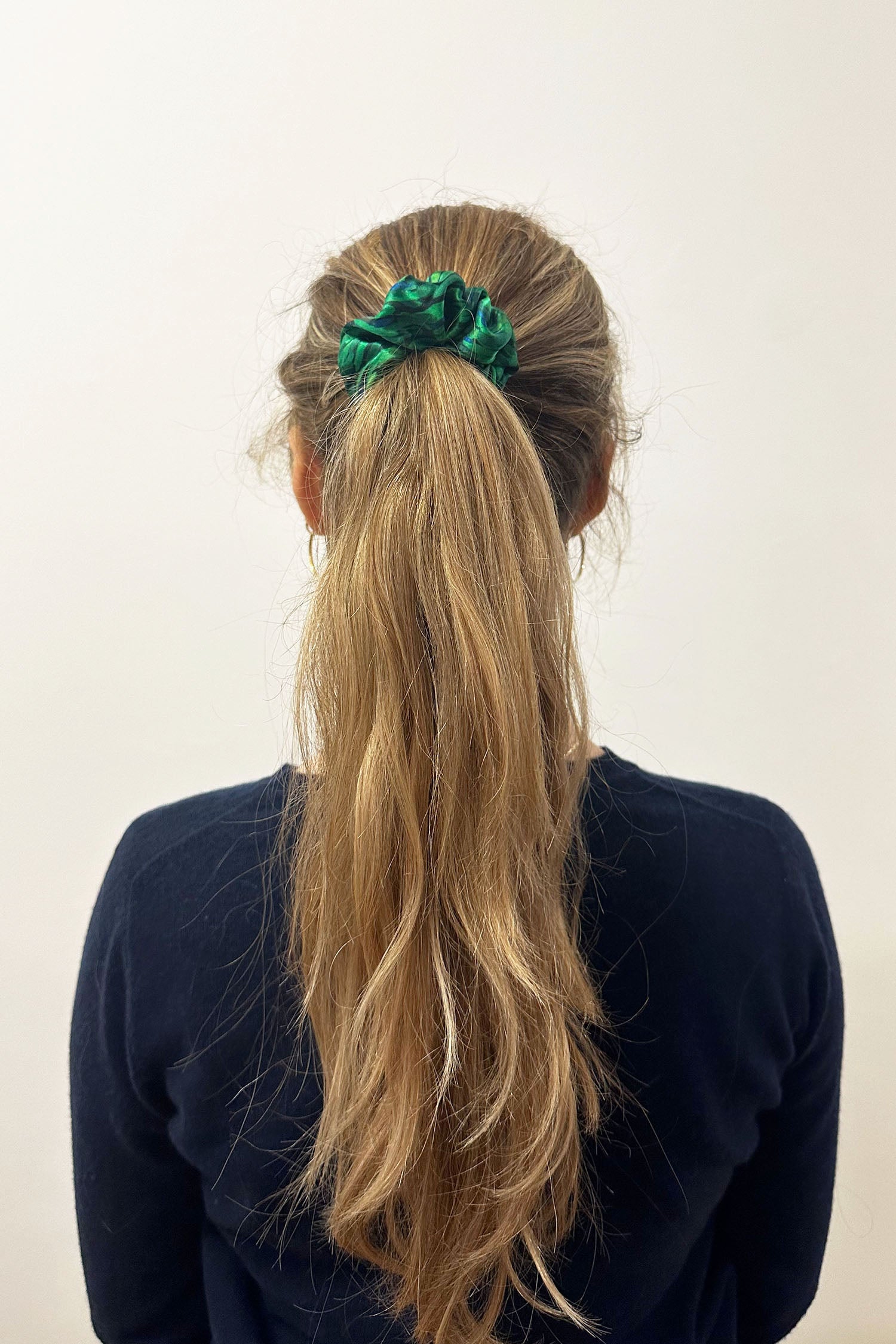 Model wearing vibrant green print silk satin scrunchie.