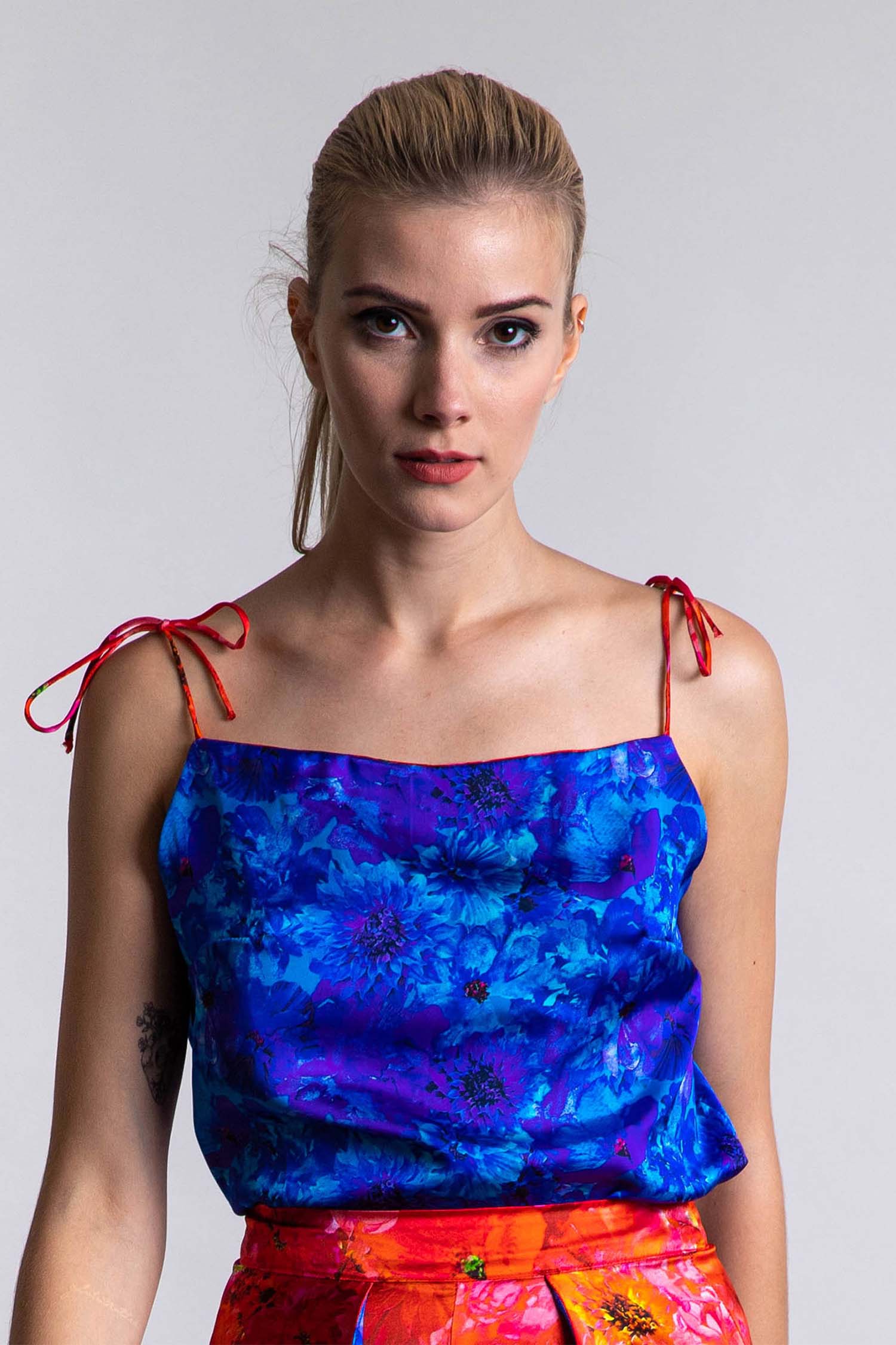 An Isabel Manns reversible silk satin slip top with v-back neckline in vibrant floral blue print.
