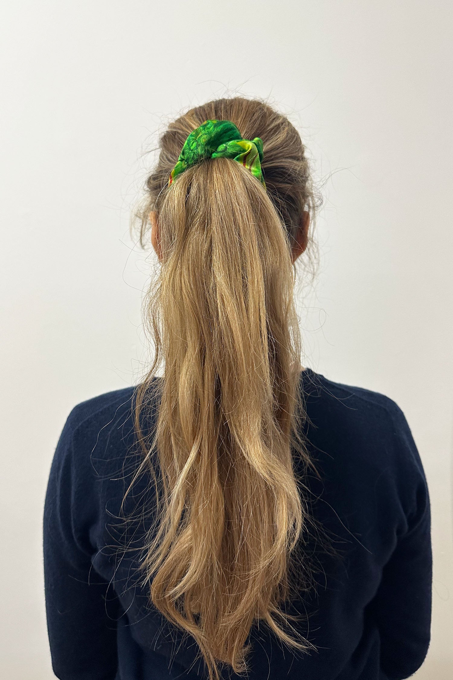 Model wearing yellow and green print silk satin scrunchie.
