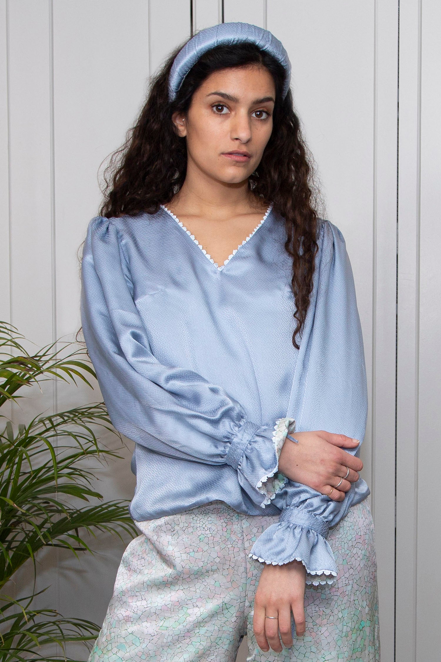 Reversible long sleeve cotton top with peplum cuff in pastel blue, worn with padded headband.