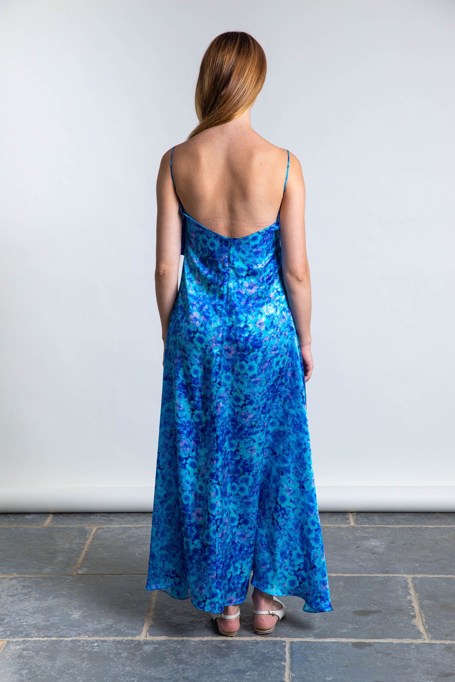 long slip dress in silk satin turquoise print worn by model back view