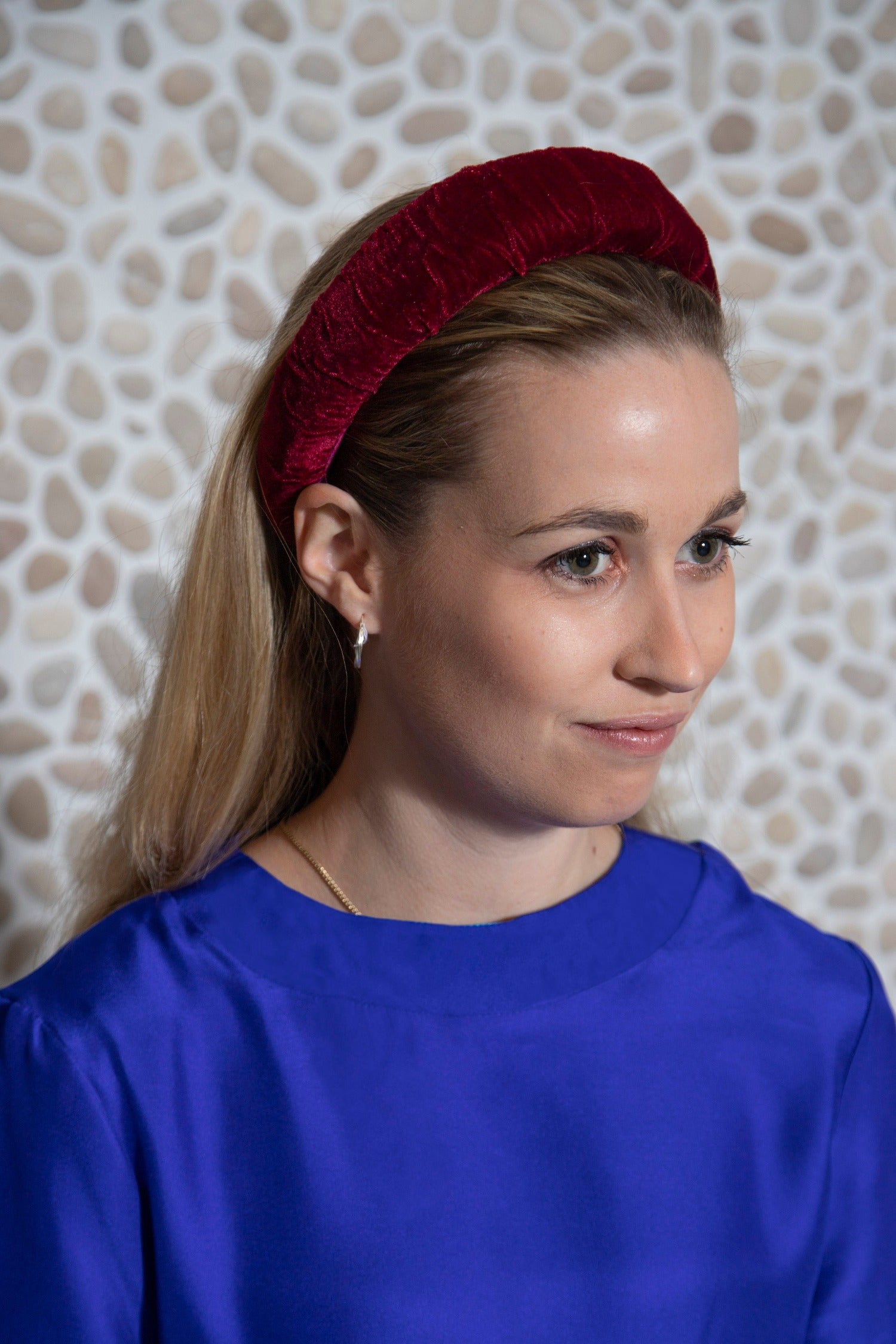 Sophisticated burgundy velvet luxurious padded headband worn by model that adds an elegant finish to your outfit