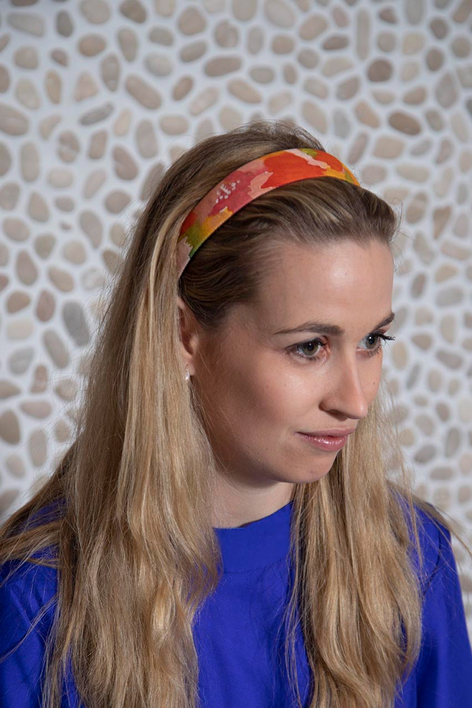 Multi coloured vibrant printed cotton headband worn by a model