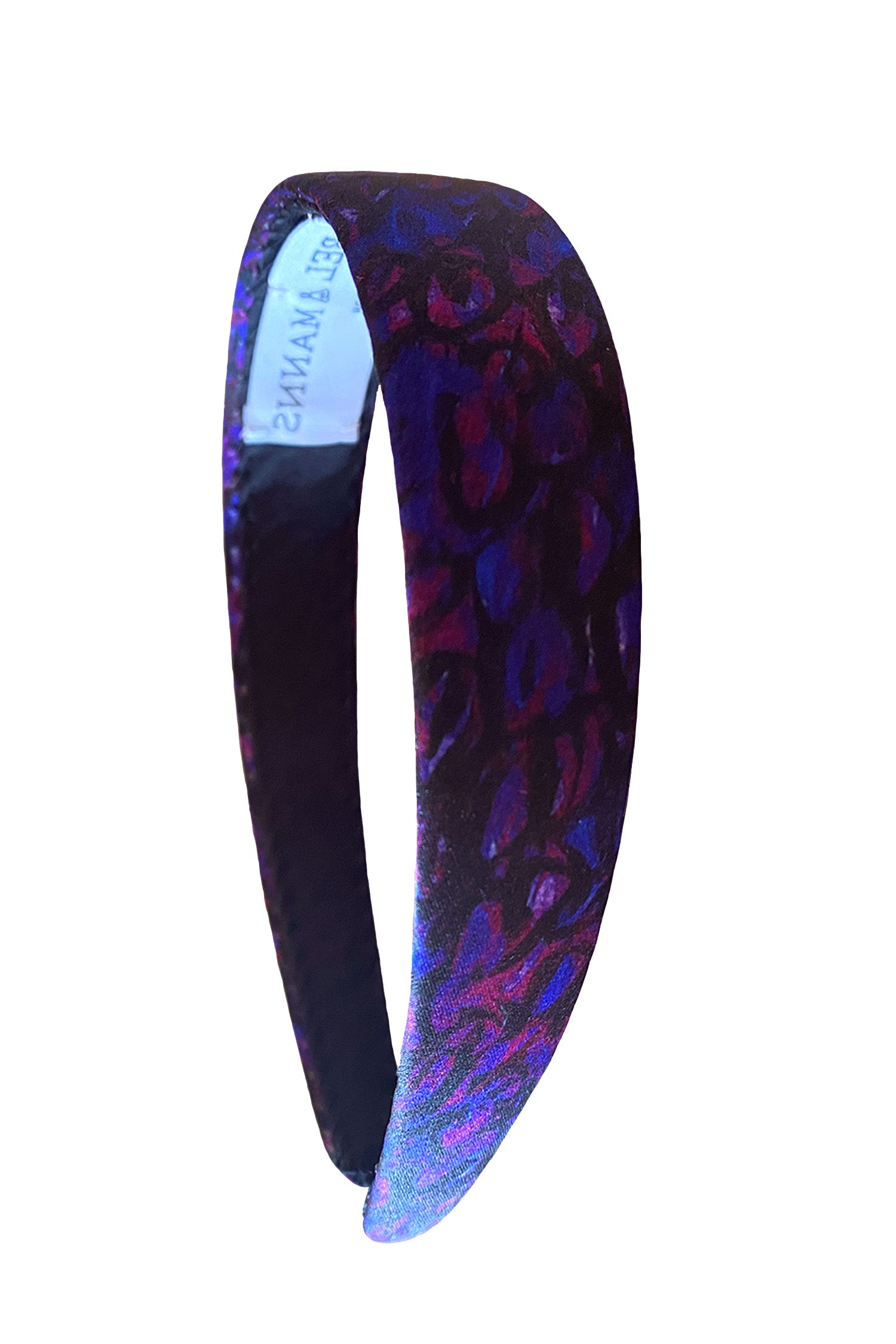 A silk headband in a dark purplesilk satin print. The print is easy to style due to a versatile range of purple and black colours.