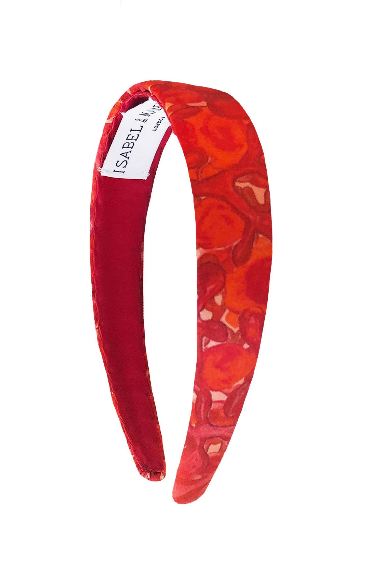 A vibrant pink and red swirly printed silk satin headband