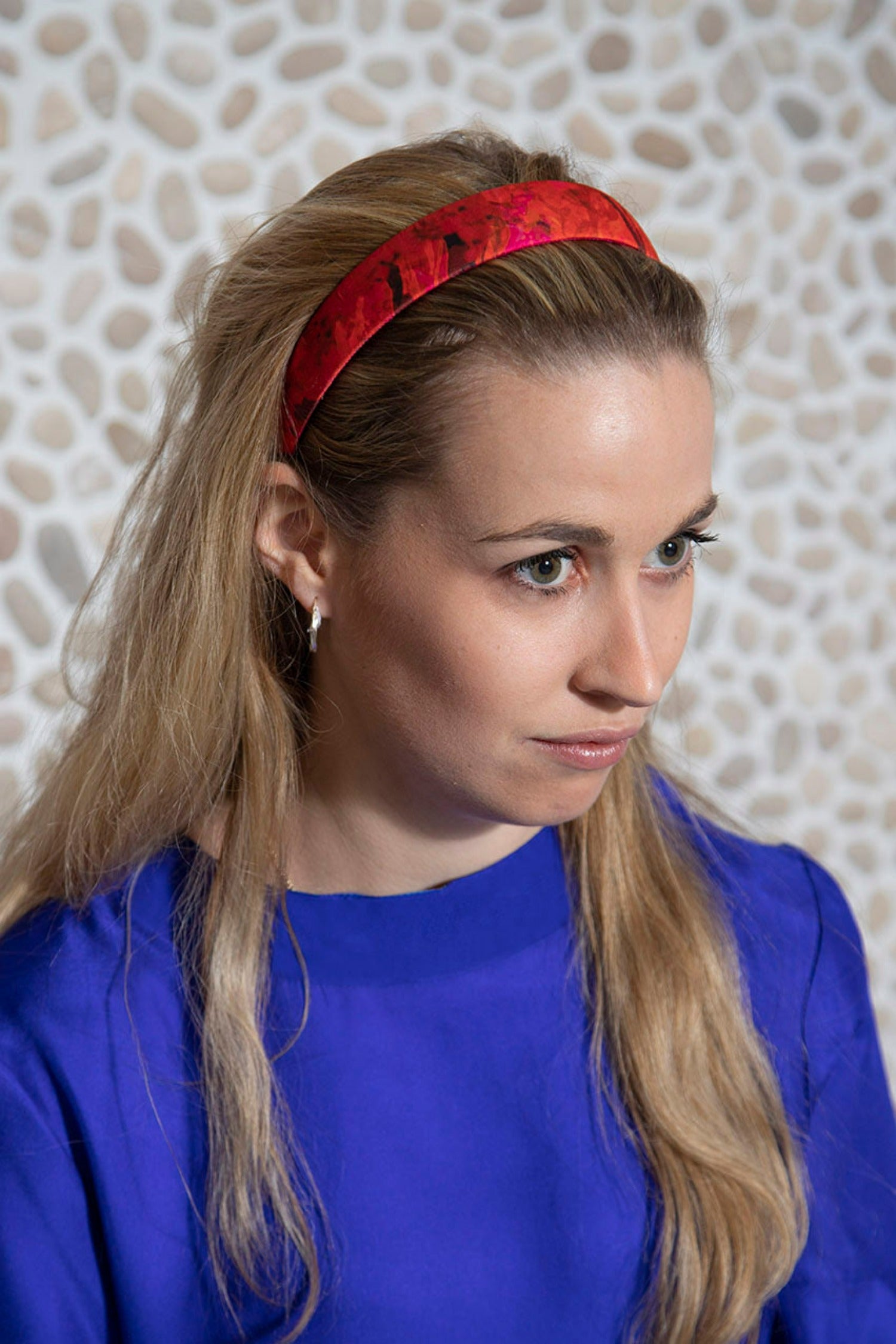 A vibrant red and pink satin printed headband handmade in London