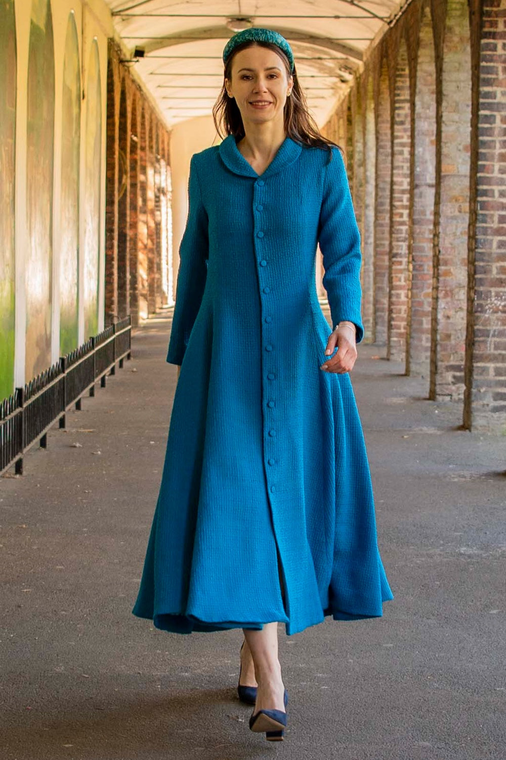Aurora coat dress front view Teal Textured Wool on a model in motion.