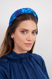 Elegant blue floral printed satin headband worn by model that is hand-made in UK sustainably
