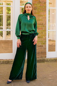 Forest green silk long sleeve halter neck top and velvet palazzo pants front view