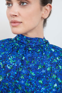 Gathered neckline detail halter neck silk bamboo top with long raglan sleeves with tie collar in blue floral print.