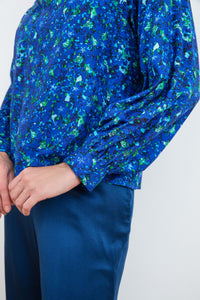 Gathered cuff detail halter neck silk bamboo top with long raglan sleeves with tie collar in blue floral print.