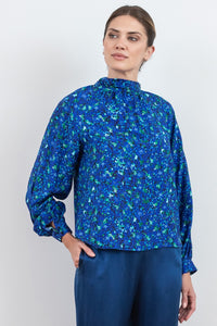 Halter neck silk bamboo top with long raglan sleeves with tie collar in blue floral print.