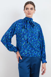 An Isabel Manns halter neck silk bamboo top with long raglan sleeves with tie collar in blue floral print, front bow tie detail.