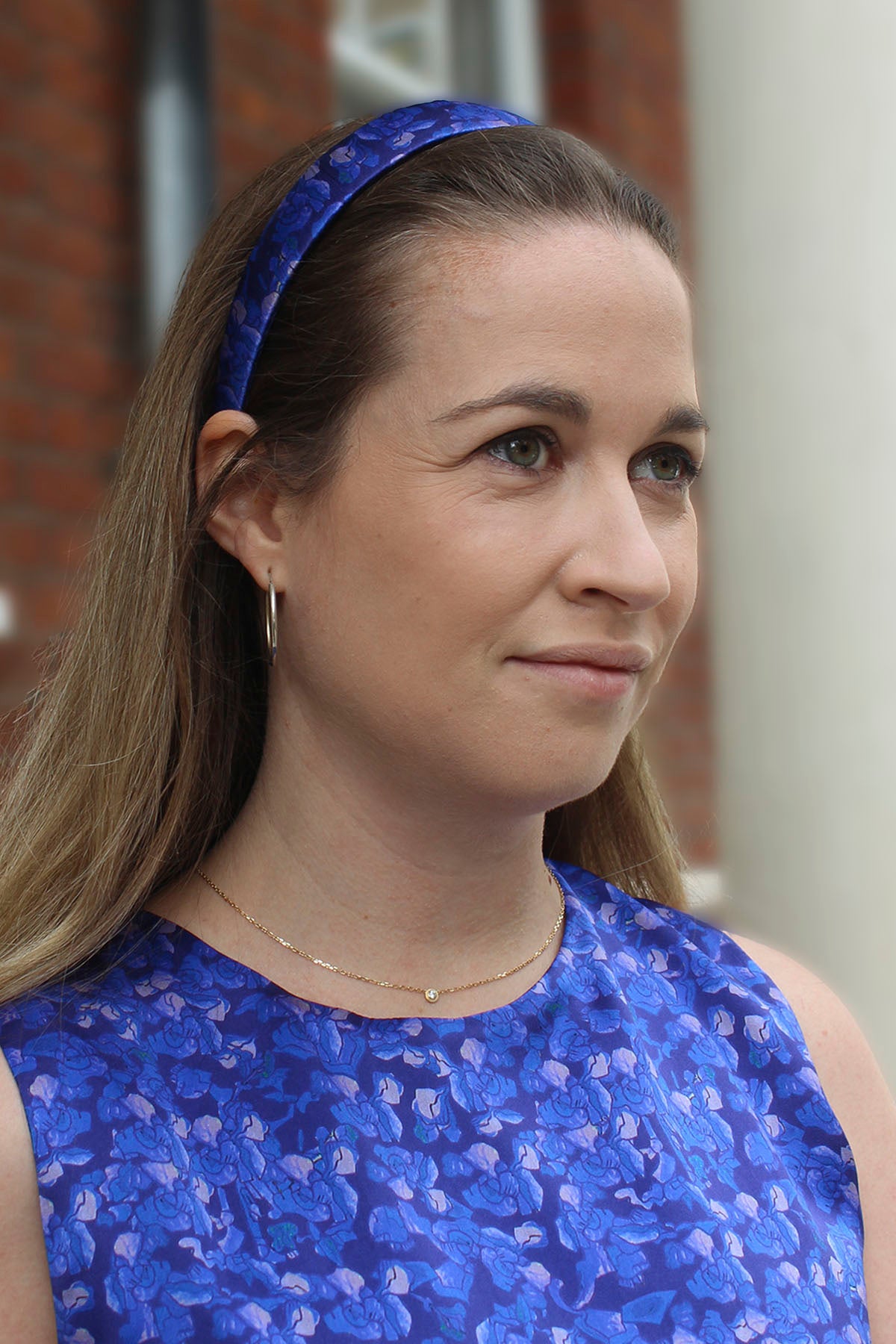 a woman wearing a silk satin blue floral headband