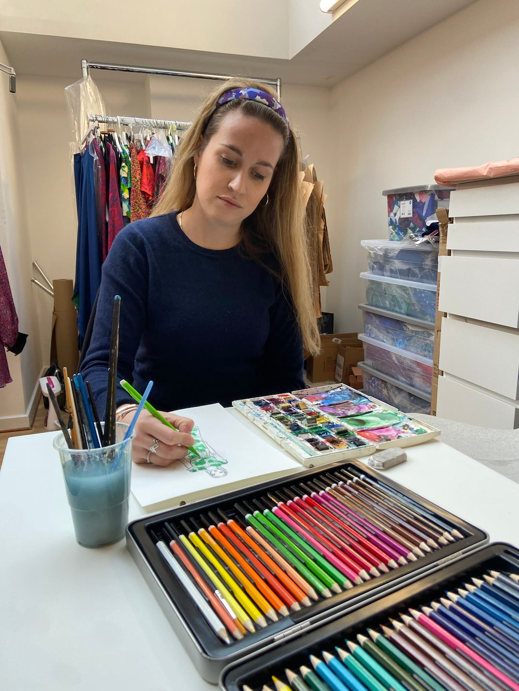 Founder Isabel Manns painting her dress designs in the London studio.