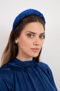 Midnight blue padded silk satin headband worn by a model that is elegant and timeless