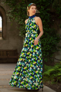 colourful vibrant printed silk satin halter neck dress with a cobalt collar and matching tie belt worn by a model