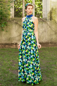 colourful vibrant printed silk satin halter neck dress with a cobalt collar and matching tie belt worn by a model