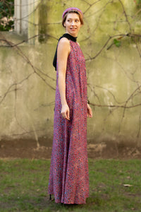 a purple printed dotted long silk satin halter neck dress with a black collar worn loosely that flows straight