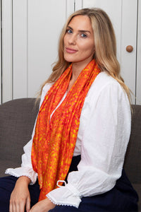 Orange silk cotton printed scarf being worn by a model