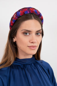 a purple and red printed silk padded headband that will brighten up an outfit as shown by a model