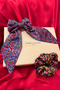 a printed gift box featuring a scrunchie and hair bow